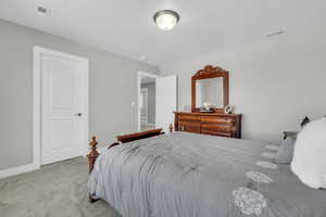 Bedroom with light carpet