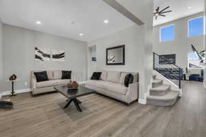 Living room featuring ceiling fan and wood-type flooring