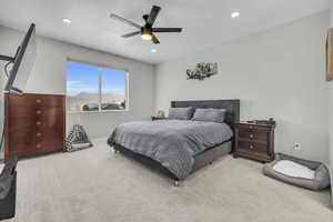 Bedroom featuring ceiling fan and light colored carpet