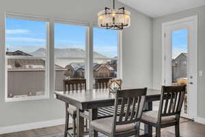 Dining room with a mountain view, hardwood / wood-style flooring, and a chandelier