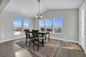 Dining room with a healthy amount of sunlight, a mountain view, and a notable chandelier