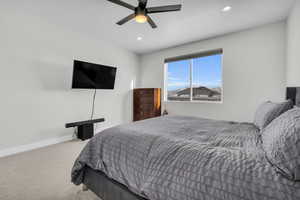 Bedroom featuring ceiling fan and carpet