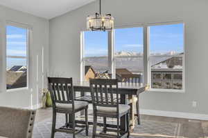 Dining area featuring a mountain view, hardwood / wood-style floors, and a chandelier