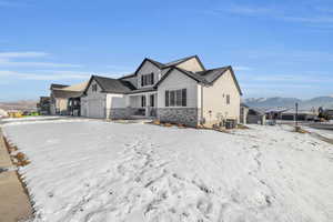 View of front of house featuring a garage, a mountain view, and central AC unit