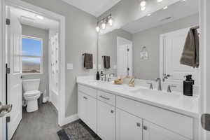 Full bathroom featuring vanity, wood-type flooring, toilet, and shower / tub combo with curtain