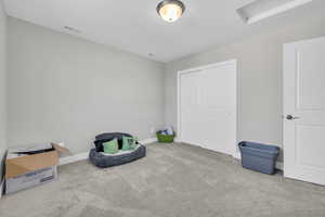 Sitting room featuring light colored carpet