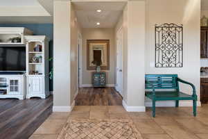 Hall featuring tile patterned flooring