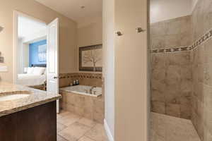 Bathroom with separate shower and tub, tile patterned flooring, and sink