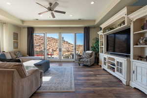 Living room with dark hardwood / wood-style floors, ceiling fan, and french doors