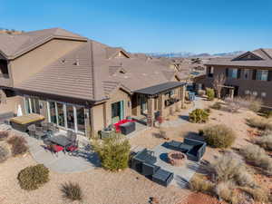 Back of house featuring a patio area and an outdoor living space with a fire pit