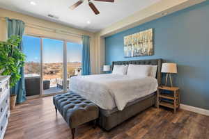 Bedroom with dark hardwood / wood-style flooring, access to outside, and ceiling fan