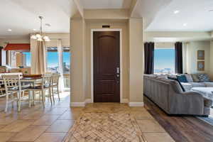 Entrance foyer featuring an inviting chandelier and plenty of natural light