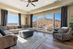 Living room featuring french doors, a healthy amount of sunlight, a mountain view, and wood-type flooring