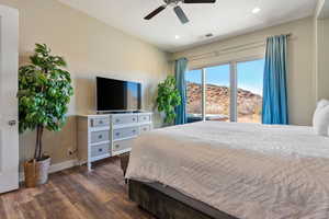 Bedroom featuring dark hardwood / wood-style flooring and ceiling fan