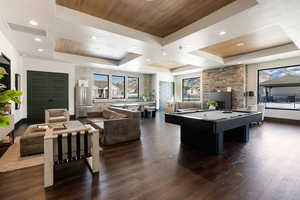 Rec room featuring dark hardwood / wood-style floors, billiards, a raised ceiling, and wooden ceiling