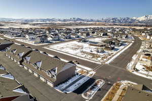 Snowy aerial view featuring a mountain view