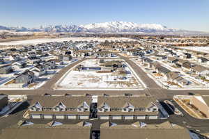 Snowy aerial view featuring a mountain view