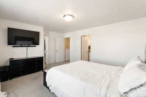 Carpeted bedroom with ensuite bath