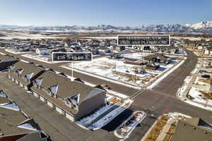 Snowy aerial view featuring a mountain view