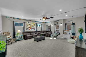 Living room featuring ceiling fan and carpet floors