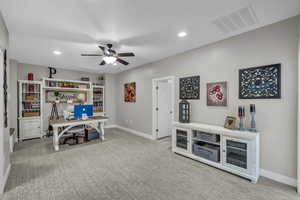 Office area featuring carpet and ceiling fan