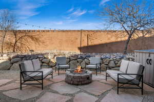 View of patio featuring an outdoor living space with a fire pit