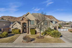 View of front of property with a garage and a mountain view