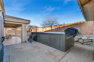 View of patio with a hot tub