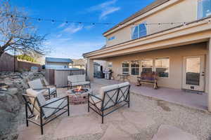 View of patio / terrace with an outdoor living space with a fire pit and a hot tub