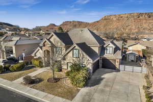 View of front of home featuring a garage, a mountain view, and a front yard