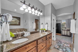 Bathroom featuring tile patterned flooring and vanity