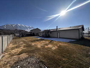 View of yard with a deck and a mountain view