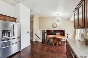 Dining room featuring an inviting chandelier and dark hardwood / wood-style flooring