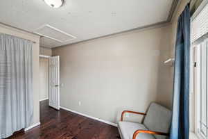 Unfurnished room featuring crown molding, dark hardwood / wood-style floors, and a textured ceiling