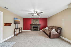 Living room with ceiling fan and carpet floors