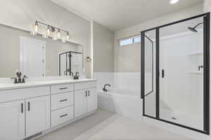 Bathroom featuring independent shower and bath, vanity, and tile patterned floors