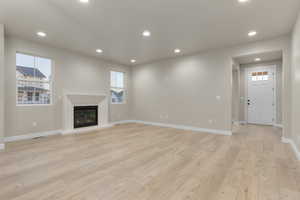 Unfurnished living room with light wood-type flooring