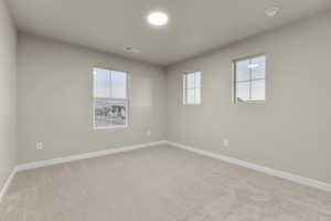 Carpeted spare room with plenty of natural light