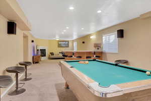 Playroom with pool table and light colored carpet