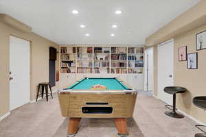 Rec room with pool table and light carpet