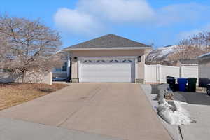 View of property exterior featuring a mountain view and a garage