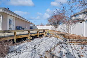 Snowy yard with a deck