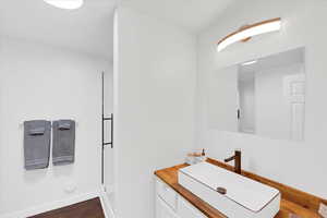 Bathroom with vanity and hardwood / wood-style floors