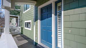 View of exterior entry featuring covered porch