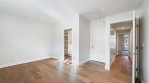 Empty room with light hardwood / wood-style flooring