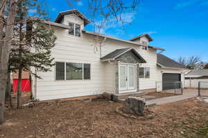 View of front of house with a garage and french doors