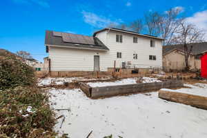 Snow covered house featuring central AC unit