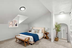 Bedroom with lofted ceiling, light colored carpet, and a textured ceiling