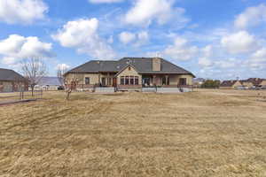 Back of house featuring a patio and a lawn