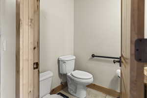 Bathroom featuring tile patterned floors and toilet